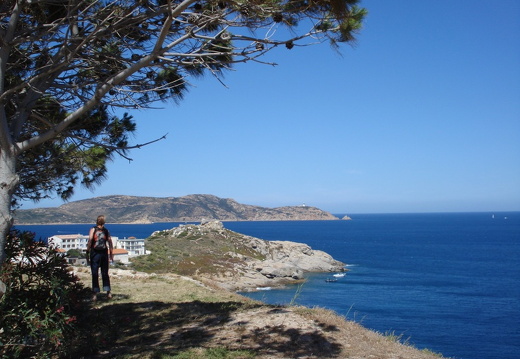 An unknown traveller gazing towards the lighthouse on the horizon