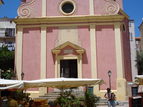 The restaurant-covered square in front of the church in Calvi