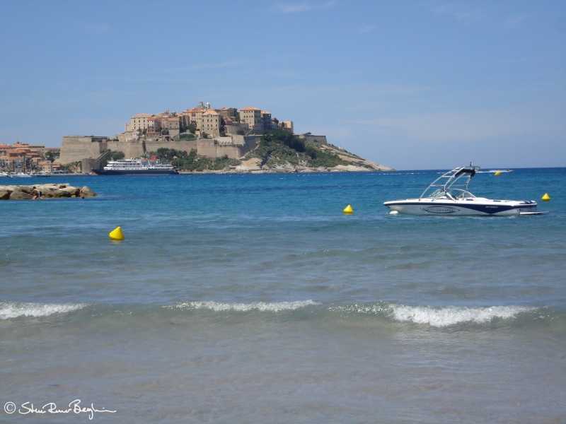 The citadel and a water jet as seen from Calvi beach