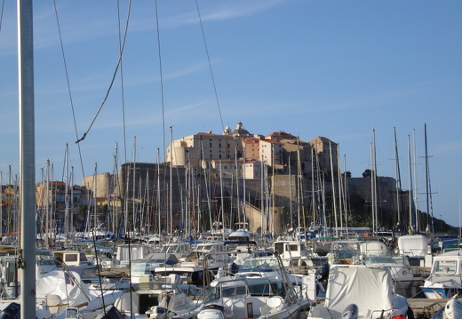 Sail boat masts in front of the citadel in Calvi