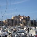 Sail boat masts in front of the citadel in Calvi