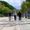 Three men walking in Parque Eduardo, Lisbon, Portugal