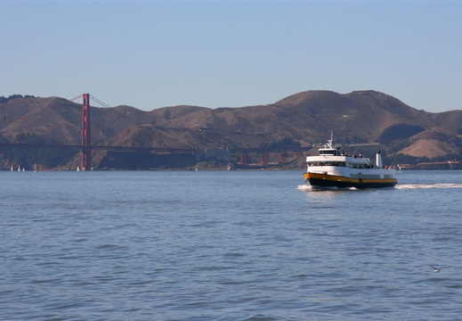 Bay cruiser passing in front of the Golden Gate bridge