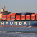 Huge cargo vessel and little flea boat