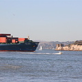 Little flea boat outrunning huge cargo vessel