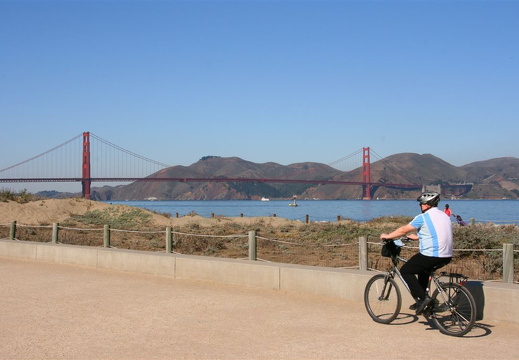 Idar cycling on beach below Golden Gate bridge
