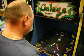 Idar playing Galaga at Santa Monica Pier arcade
