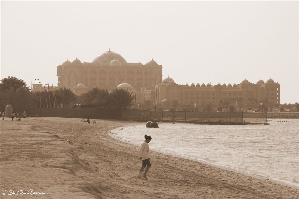 Girl on public beach in front of Emirates Palace