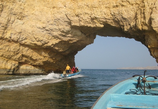 Sailing through portal rock near Barr al Jissah, Oman