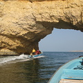 Sailing through portal rock near Barr al Jissah, Oman