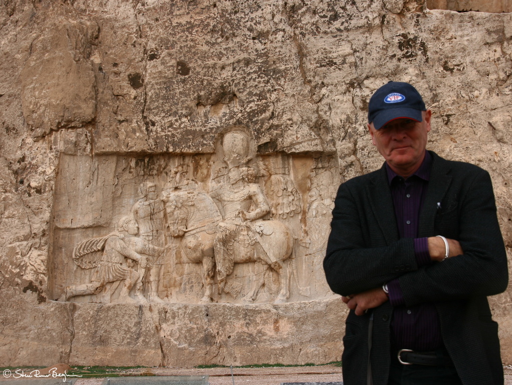 VIF member in front of rock carvings