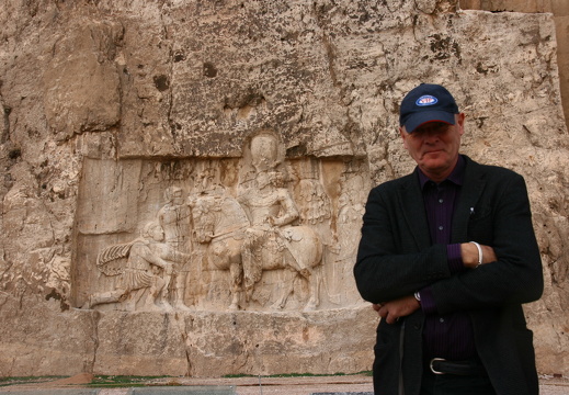 VIF member in front of rock carvings