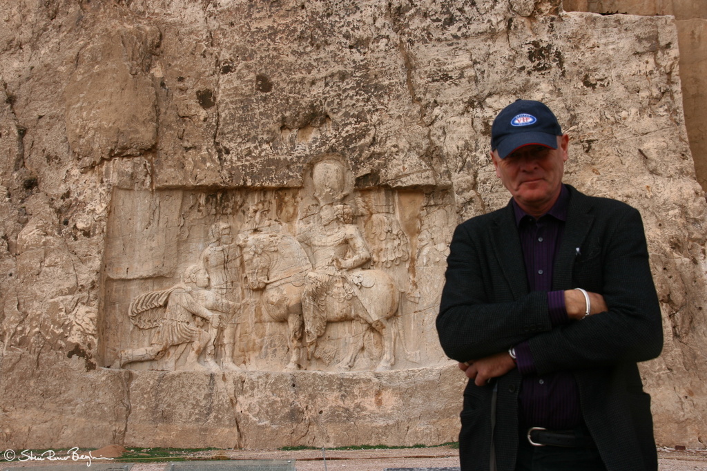 VIF member in front of rock carvings