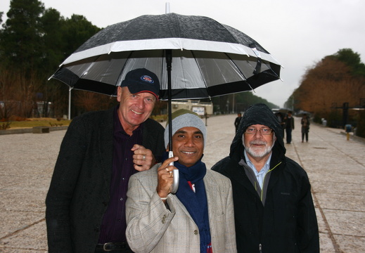 Three men and an umbrella