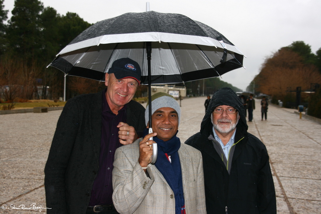 Three men and an umbrella